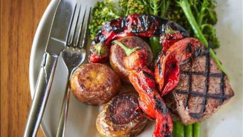 plate of food including steak potatoes and broccolini from restaurant in Berkeley California