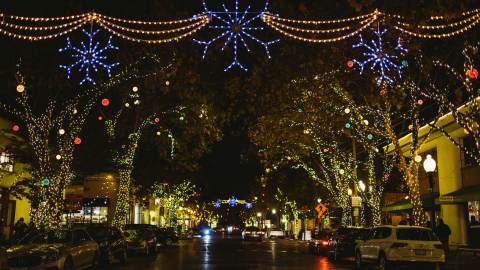 Neighborhood decorated with Christmas lights in Berkeley CA at night
 