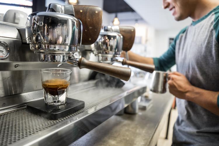 A barista makes a cup of coffee at a cafe in Berkeley. 