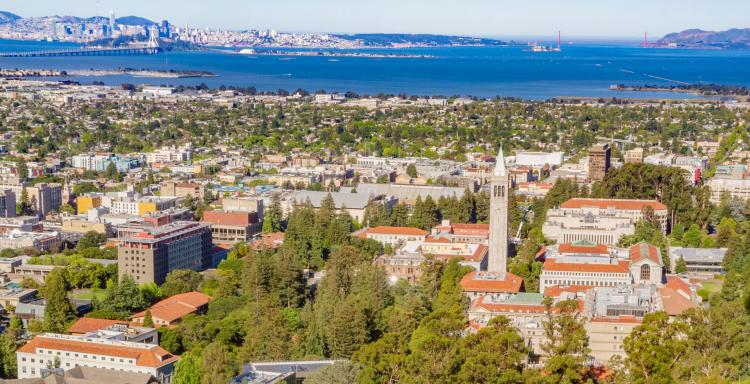 Aerial view of Berkeley at dusk. The Golden Gate Bridge is visible in the background.