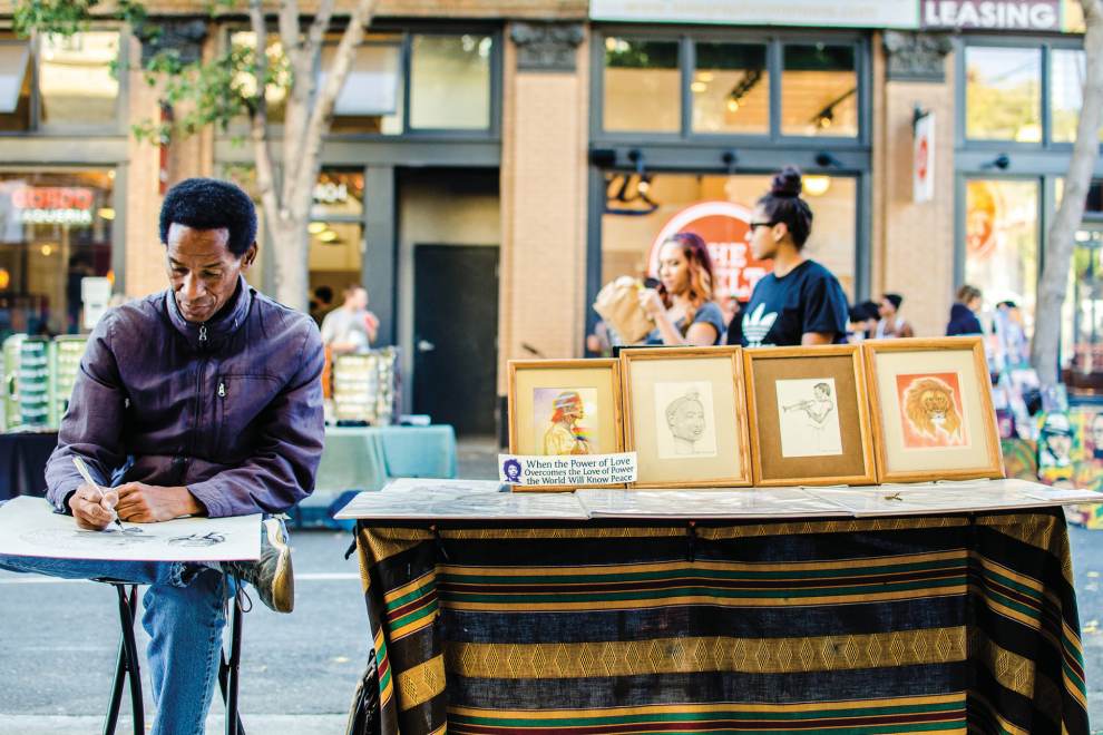 An artist creates a work of art on Telegraph Ave in downtown Berkeley, California