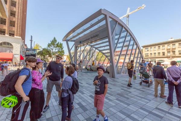 A family standing outside of the Downtown Berkeley Bart Station