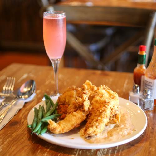 Dish of food from Angeline and drink on a dinner table in downtown Berkeley, California