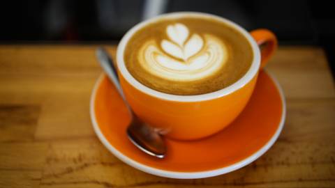 Cappuccino in orange mug on table from Rasa Cafe in Berkeley California