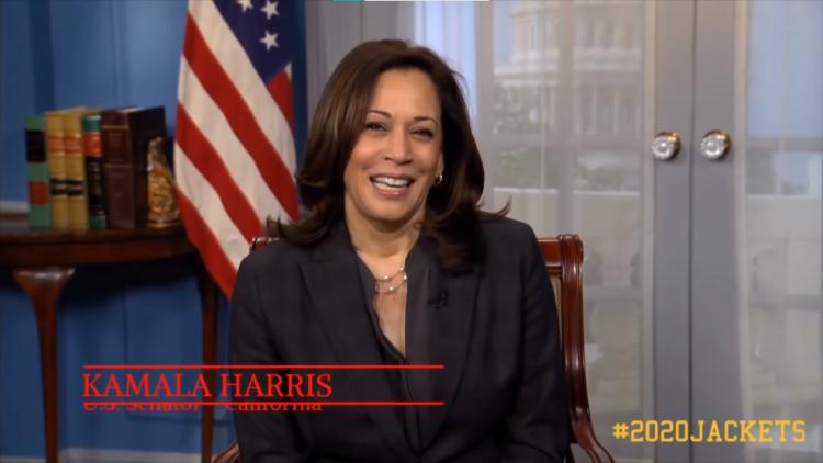 Kamala Harris sitting in front of an American flag. Her name is in red letters in the bottom left corner.