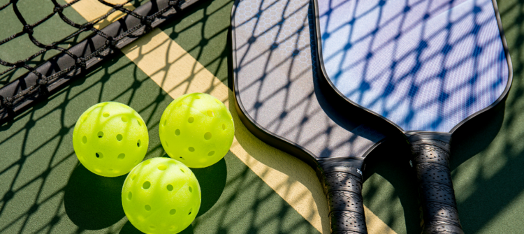 close up of pickleball balls and paddles
