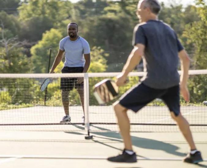 two men compete on an outdoor Pickleball court in Berkeley