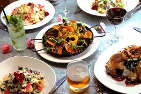 An assortment of food on white plates at Revival Kitchen and Bar