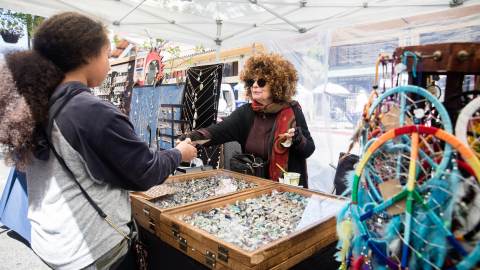 Two women shopping and chatting at the Telegraph Holiday Street Fair