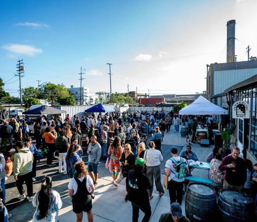 Crowd of people walk around Berkeley's Wine Block at the First Friday Block Party