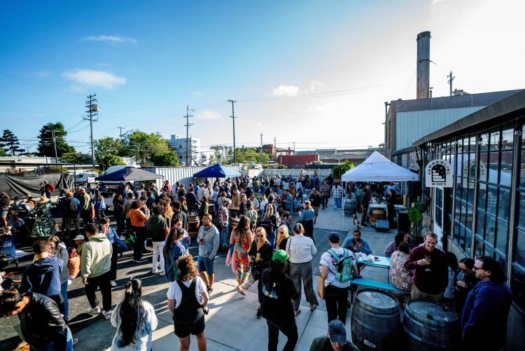 Crowd of people walk around Berkeley's Wine Block at the First Friday Block Party