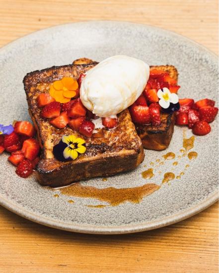 A plate of French toast with strawberries and edible flowers from Gather in Berkeley