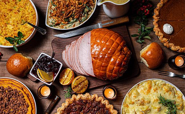 A Thanksgiving spread of turkey, pie, and sides taken from above