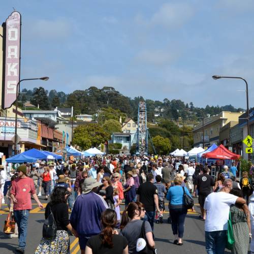 people fill the street and enjoy vendor booths during the Solano Stroll Street Fair In Berkeley Every September